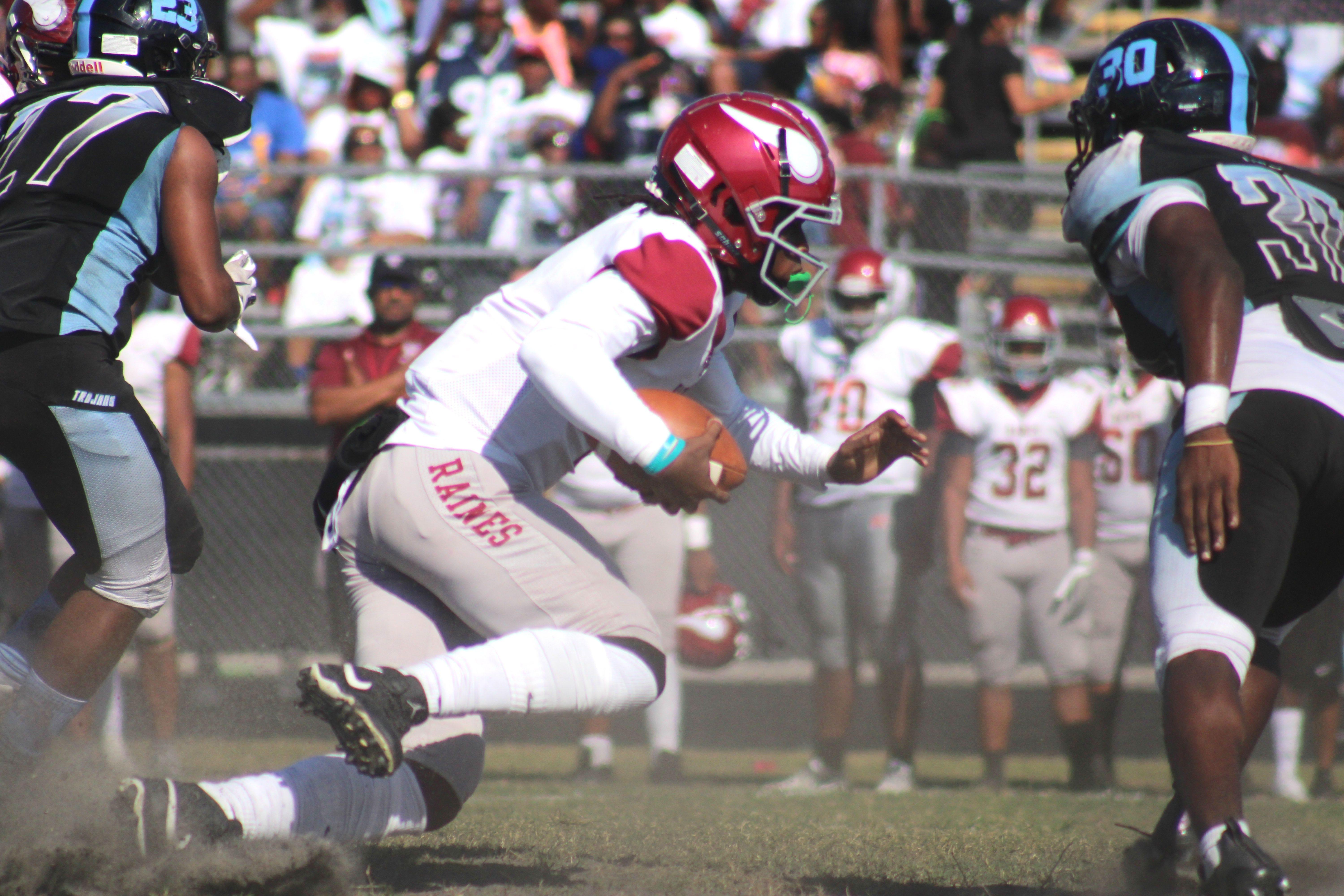 Raines quarterback Carleton Butler Jr. (1) dives to the 1-yard line, setting up a touchdown one play later, during the 52nd Northwest Classic high school football game on October 23, 2021. Butler scored two rushing touchdowns and two passing touchdowns in the game. [Clayton Freeman/Florida Times-Union]