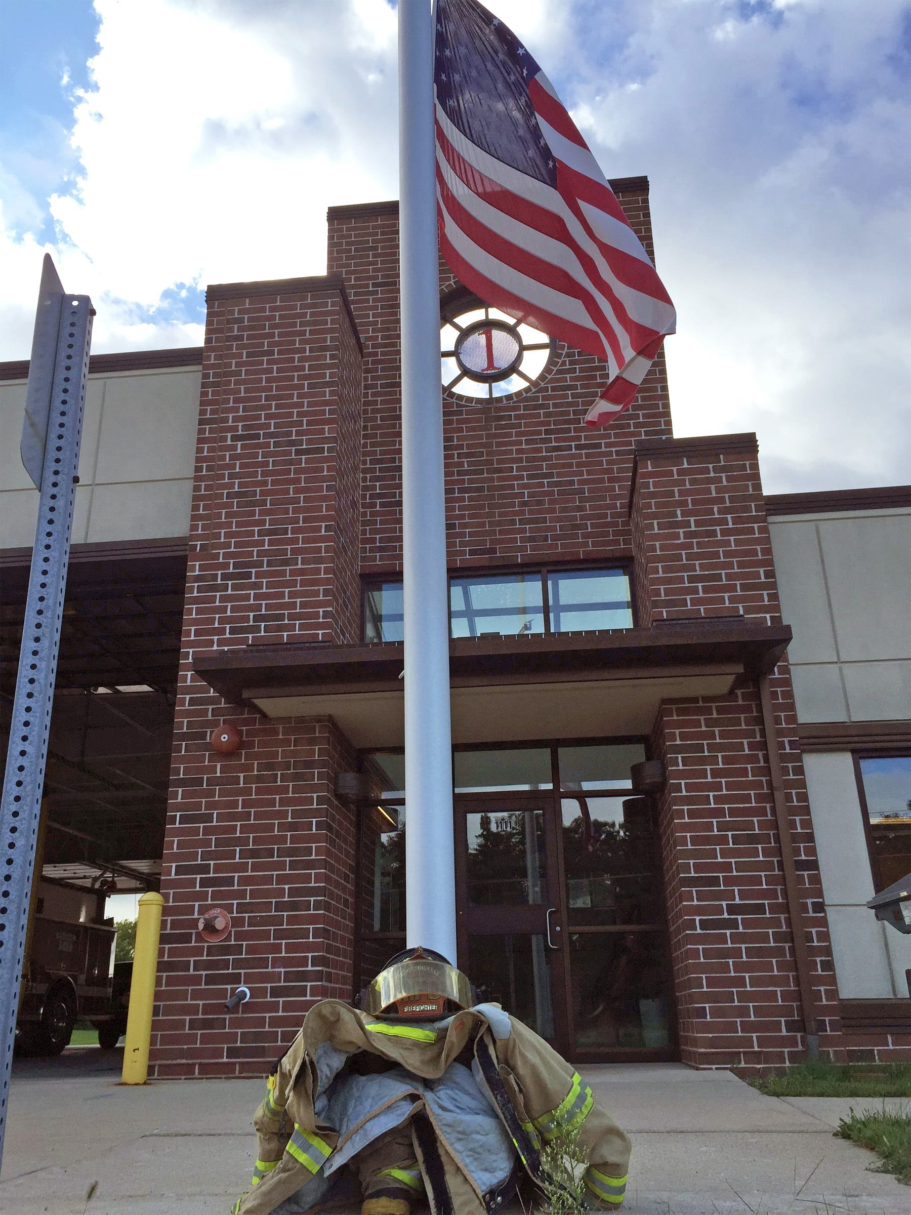 Gear sits in front of a flag at half staff by the Mukwonago Fire Department on Sept. 11. Members of the police and fire departments paused for a moment of silence in honor of those who lost their lives on Sept. 11, 2001.