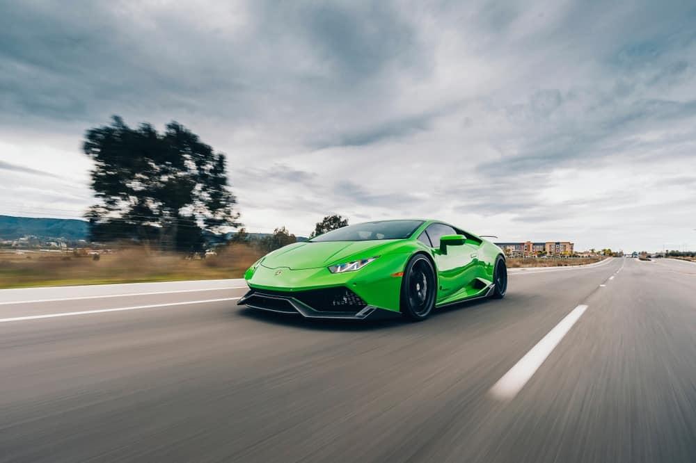 supercar Lamborghini Huracan finished in green in the motion.