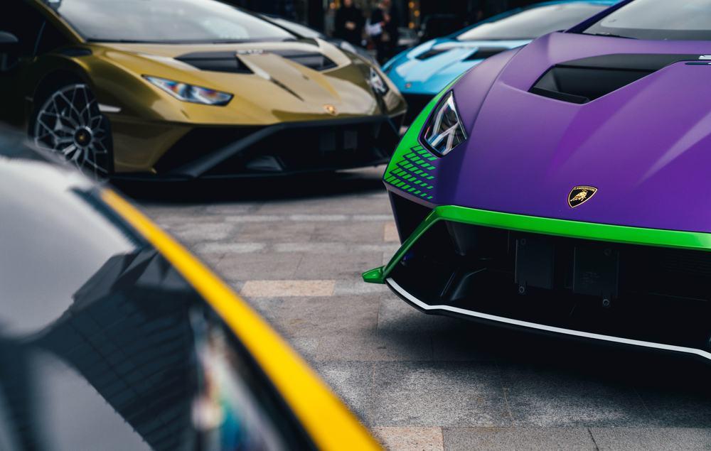 Four Lamborghini Huracan STO hypercars are parked in courtyard