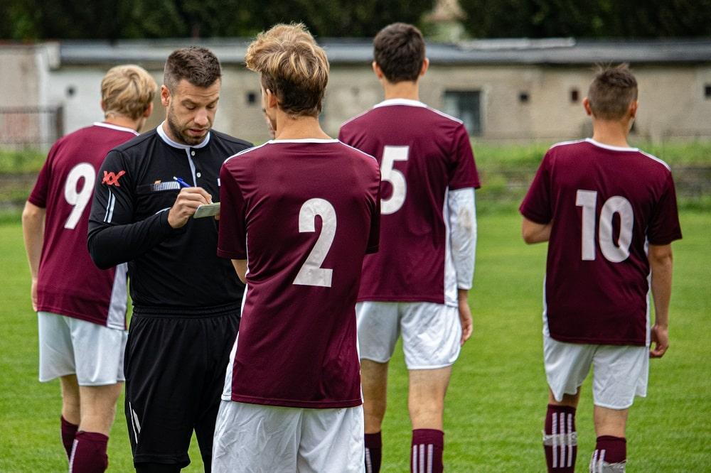 A close look at a player being given a warning by the referee.