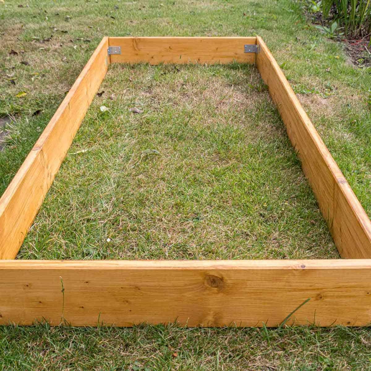 A raised garden bed that is not planted and is going fallow.