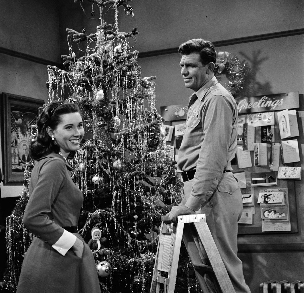 (L to R): Actor Elinor Donahue as Ellie Walker and Andy Griffith as Sheriff Andy Taylor decorate a Christmas tree in a scene from