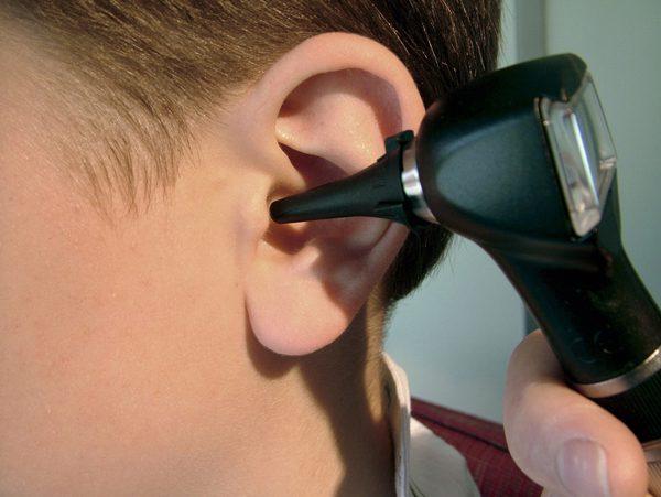 childs ear is being examined using hearing instrument