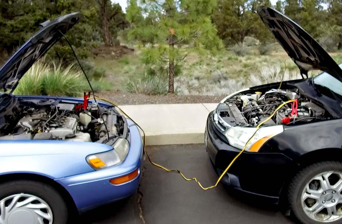 Two cars together with one being jump-started