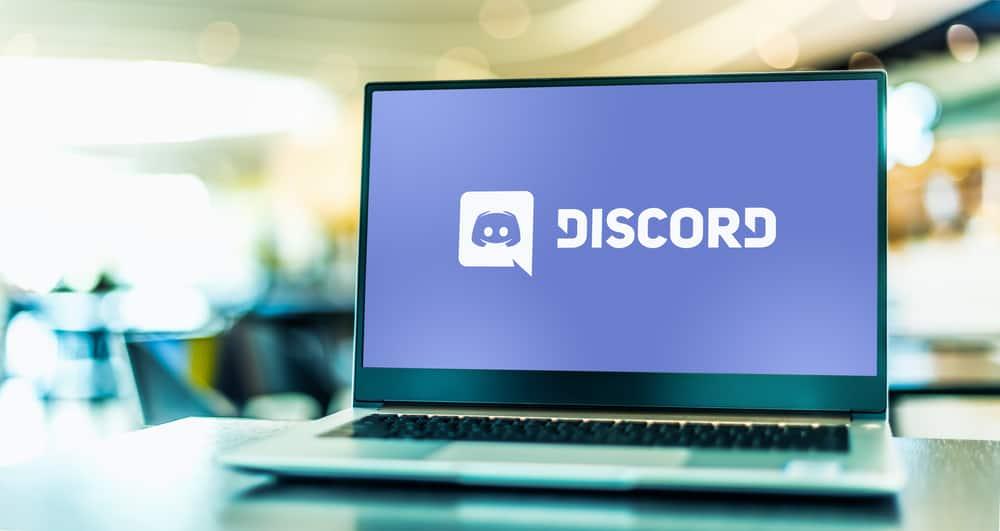 Laptop computer displaying logo of Discord, a VoIP, instant messaging and digital distribution platform designed for creating communities