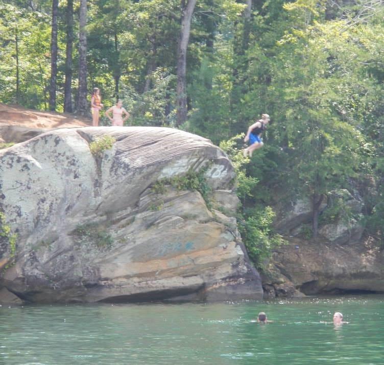 Children jump off "the rock" near Fall Creek Landing on Lake Keowee.