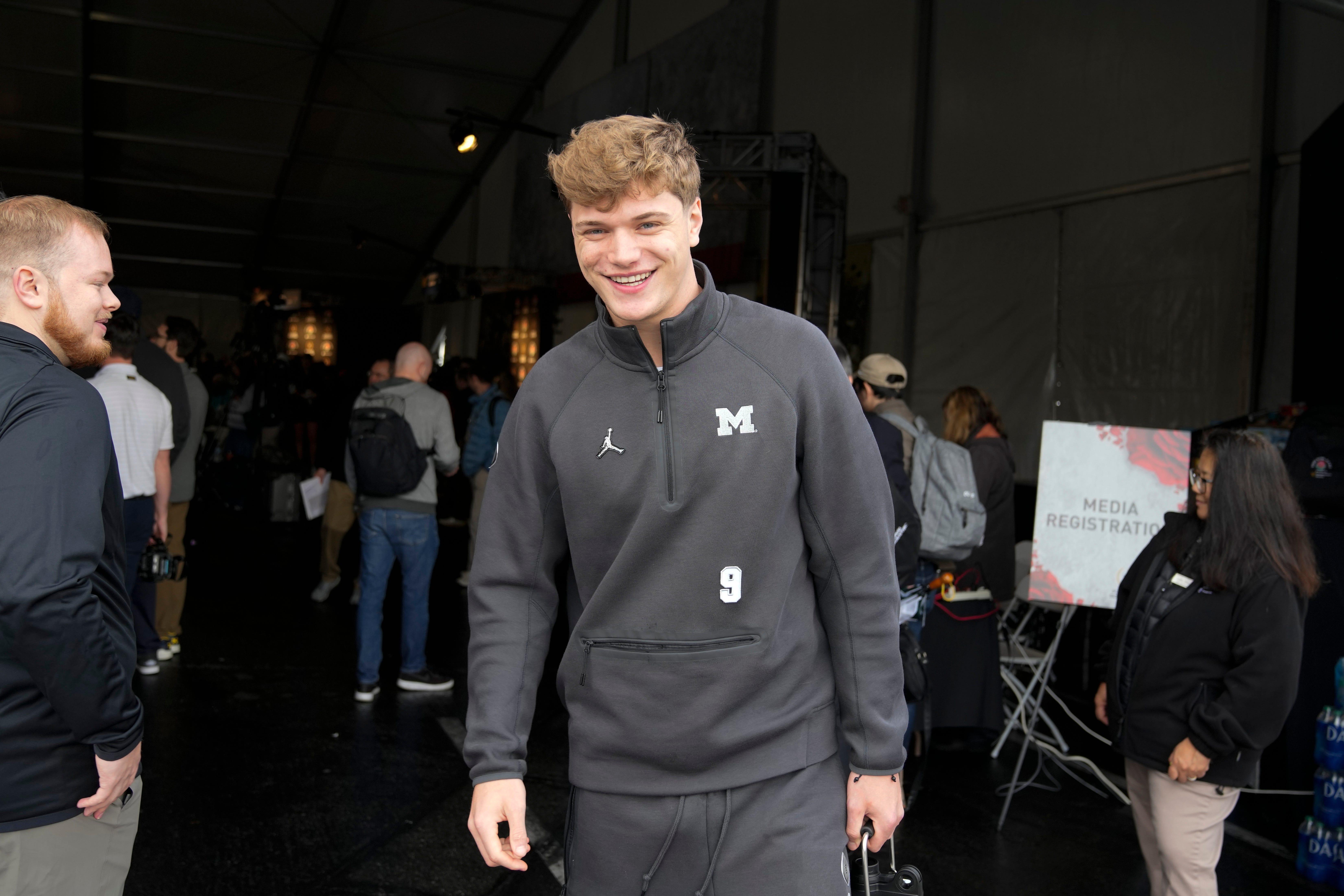 Michigan quarterback J.J. McCarthy smiles while leaving media day Saturday, Dec. 30, 2023, in Pasadena, Calif. Michigan is scheduled to play against Alabama on New Year