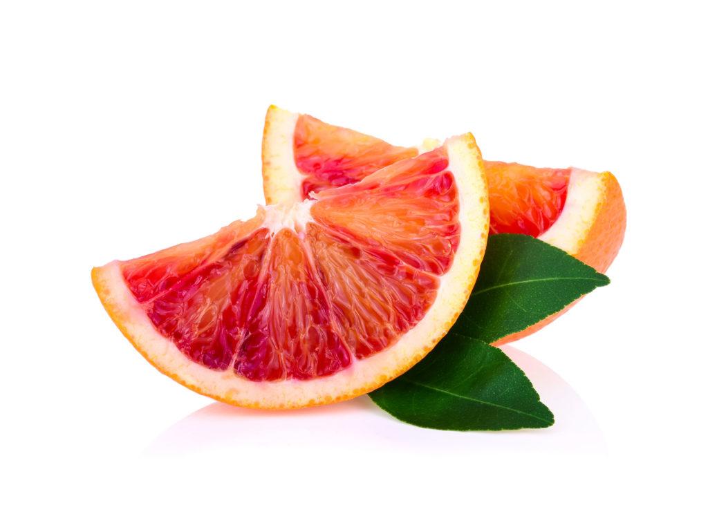 A slice of blood orange against the white background