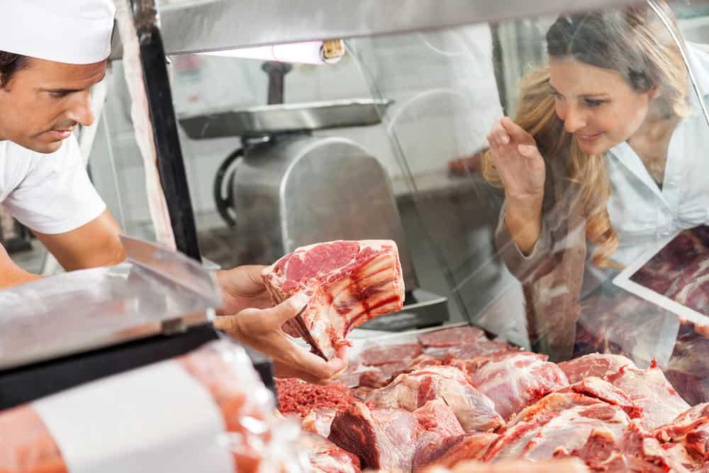 Mature woman buying fresh meat at butchery