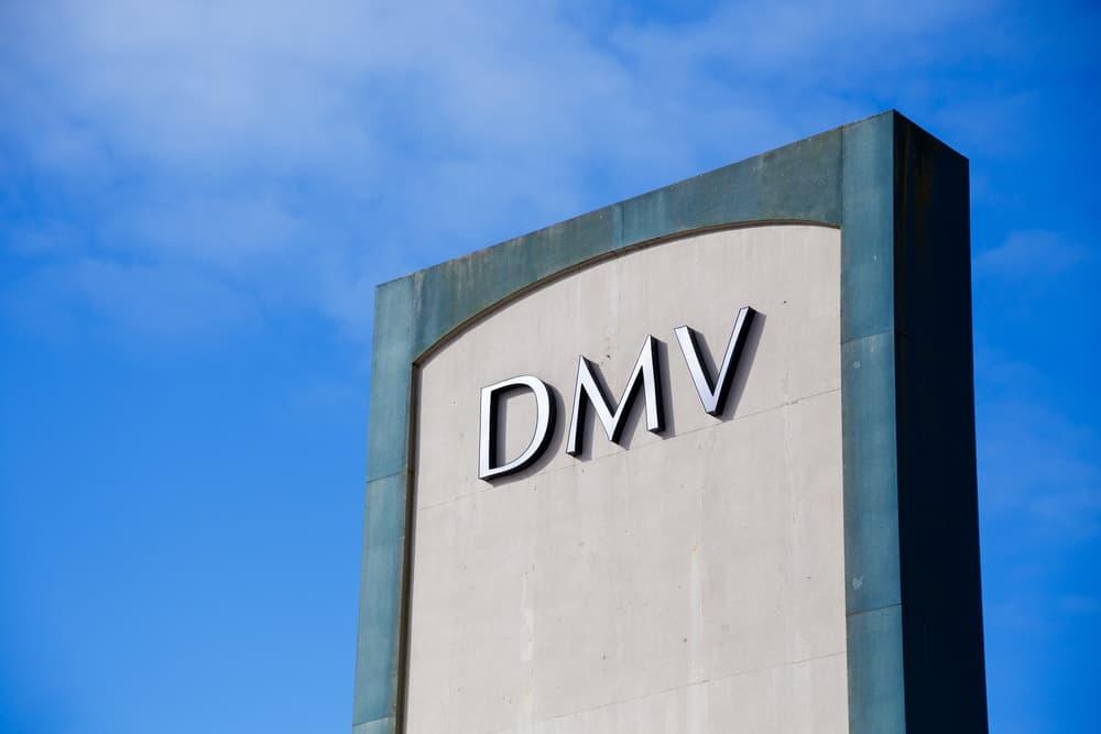 DMV or Department of Motor Vehicles sign against a blue sky