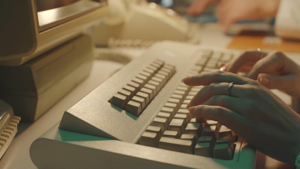 typing on a keyboard and using computer in a vintage lab