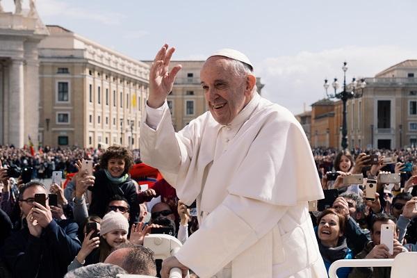 Pope Francis waving to the crowds in the Vatican City