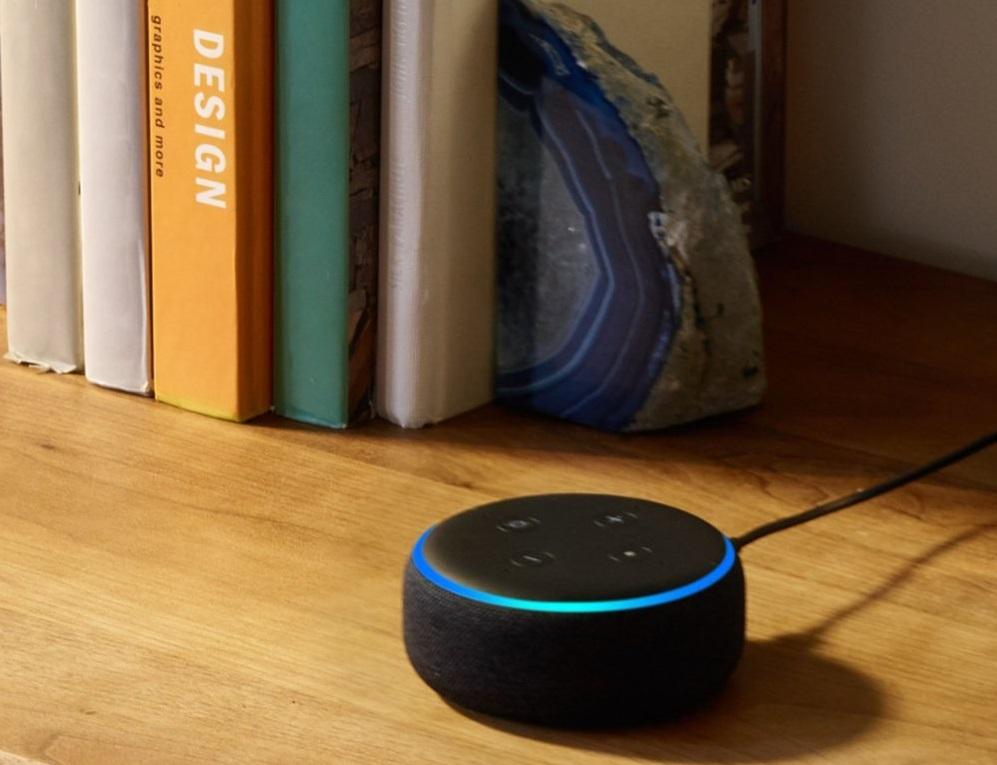 Echo device sitting on table with blue light ring.