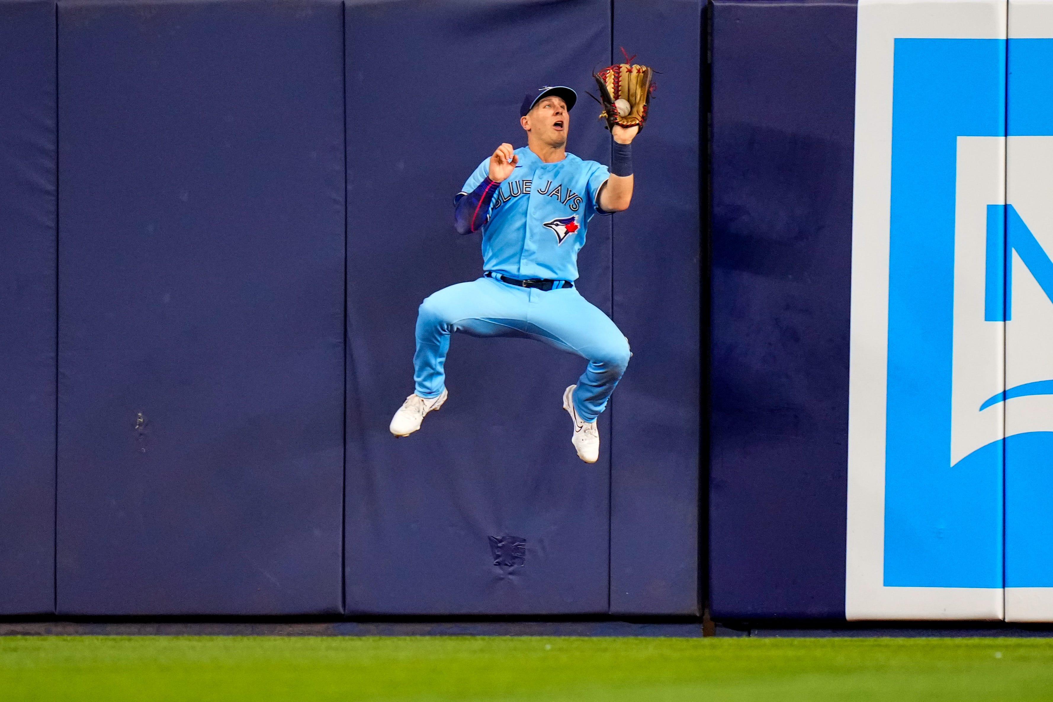 Toronto Blue Jays left fielder Daulton Varsho catches a fly ball against the Miami Marlins.