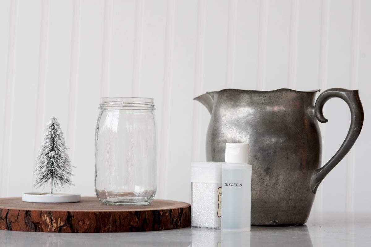 Empty mason jar alongside a miniature tree - snow globe supplies