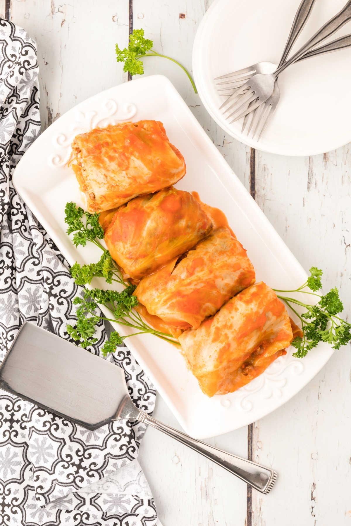 Overhead view of cabbage rolls on a serving platter.