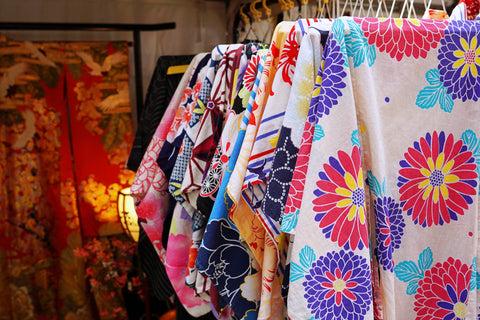 a rack with many kimonos