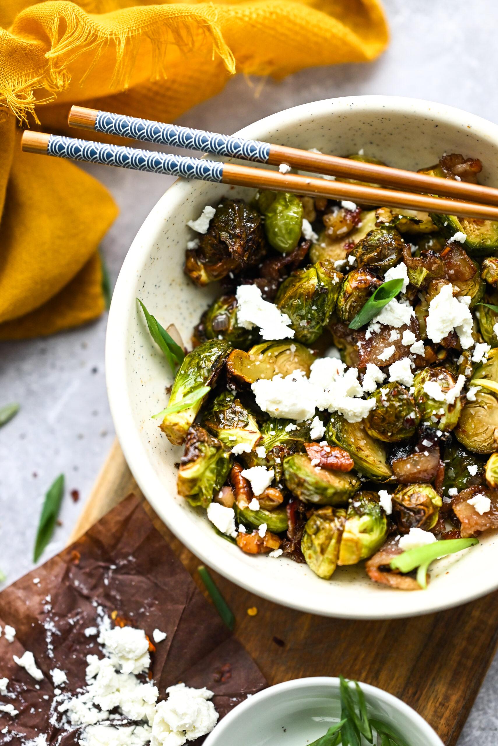 air fryer brussels sprouts with goat cheese in a white bowl.