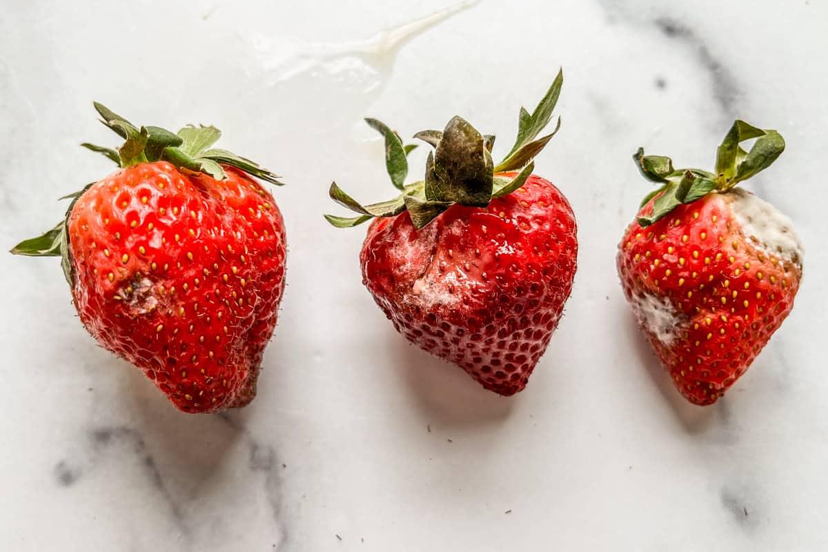 Three rotten strawberries.