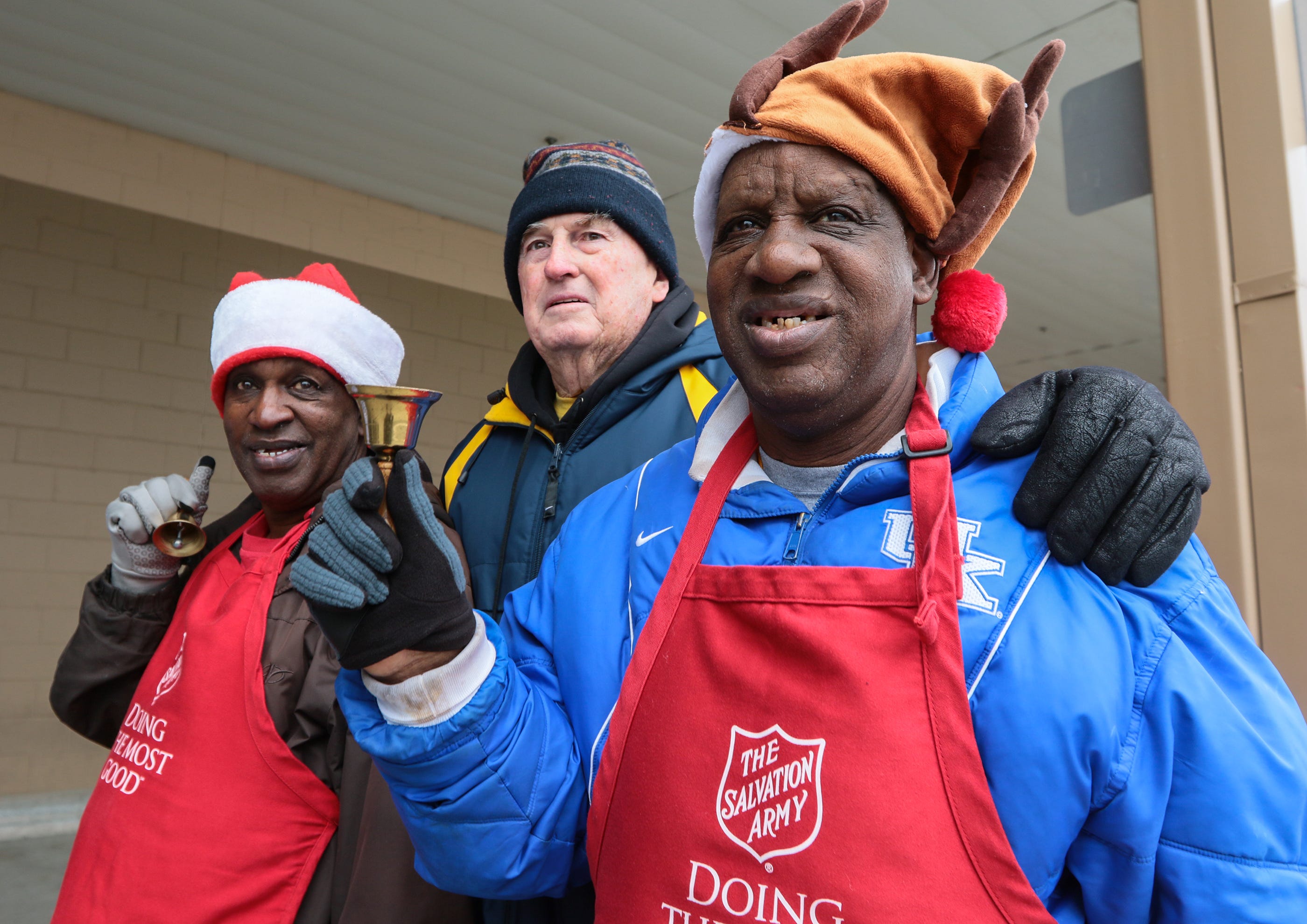 George "Cool Rock" Kennedy, left, Harold Jones, and James Robert "Radio" Kennedy of Anderson ring bells at a Salvation Army Red Kettle on Saturday at the Sam