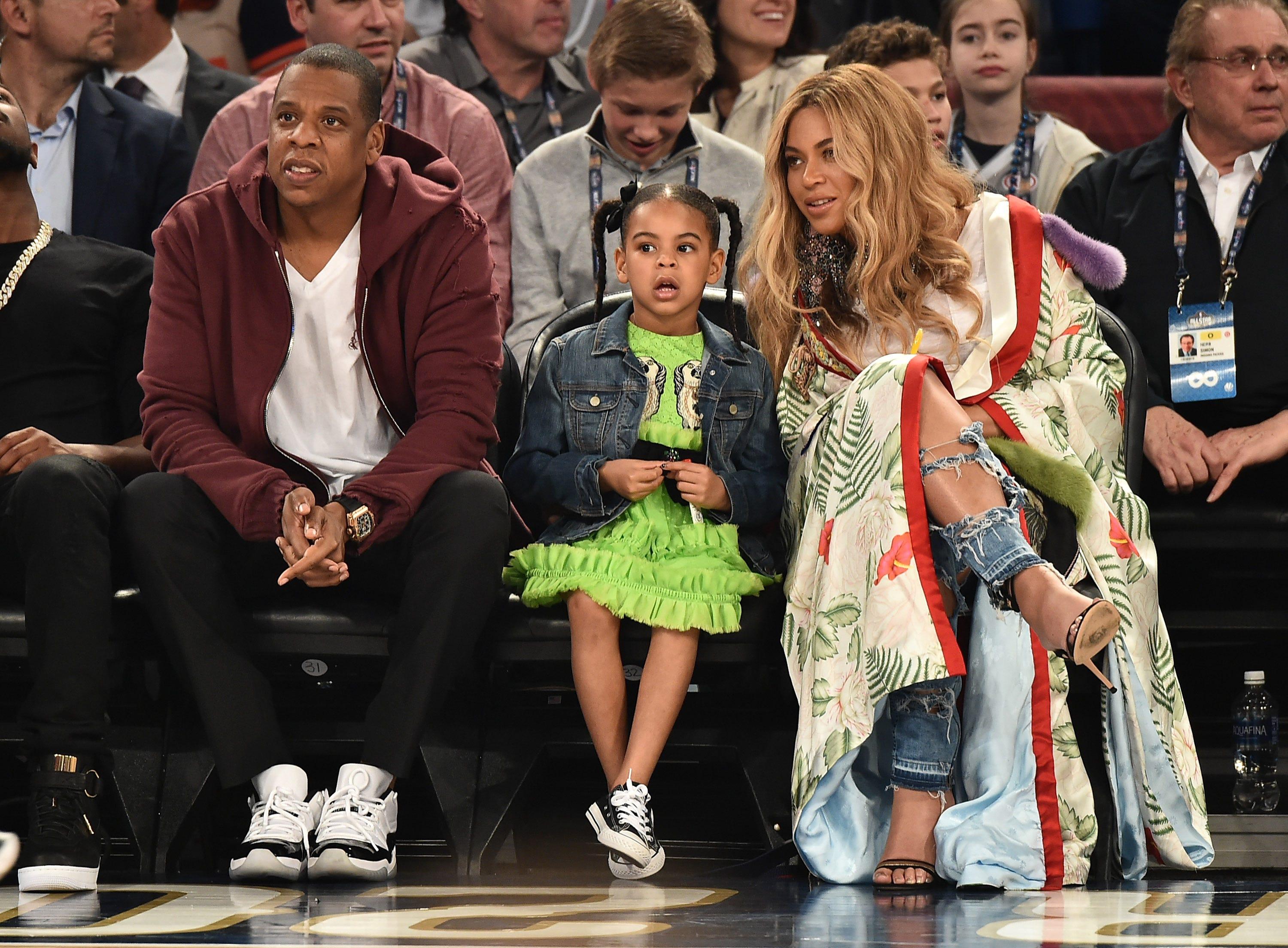 (L-R) Jay-Z, Blue Ivy Carter, and Beyoncé Knowles-Carter attend the 66th NBA All-Star Game at Smoothie King Center on Feb. 19, 2017, in New Orleans, Louisiana.