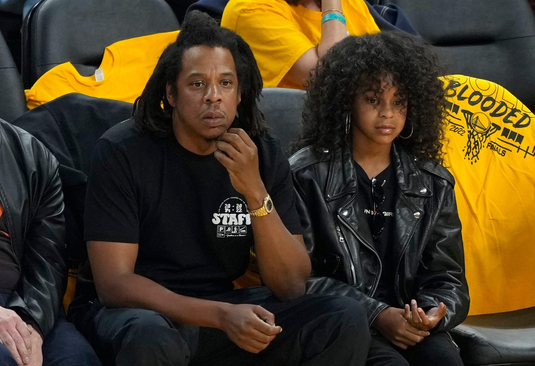 Rapper Jay-Z and his daughter Blue Ivy Carter look on during the second quarter of Game 5 of the 2022 NBA Finals between the Boston Celtics and the Golden State Warriors at Chase Center on June 13, 2022, in San Francisco, California.