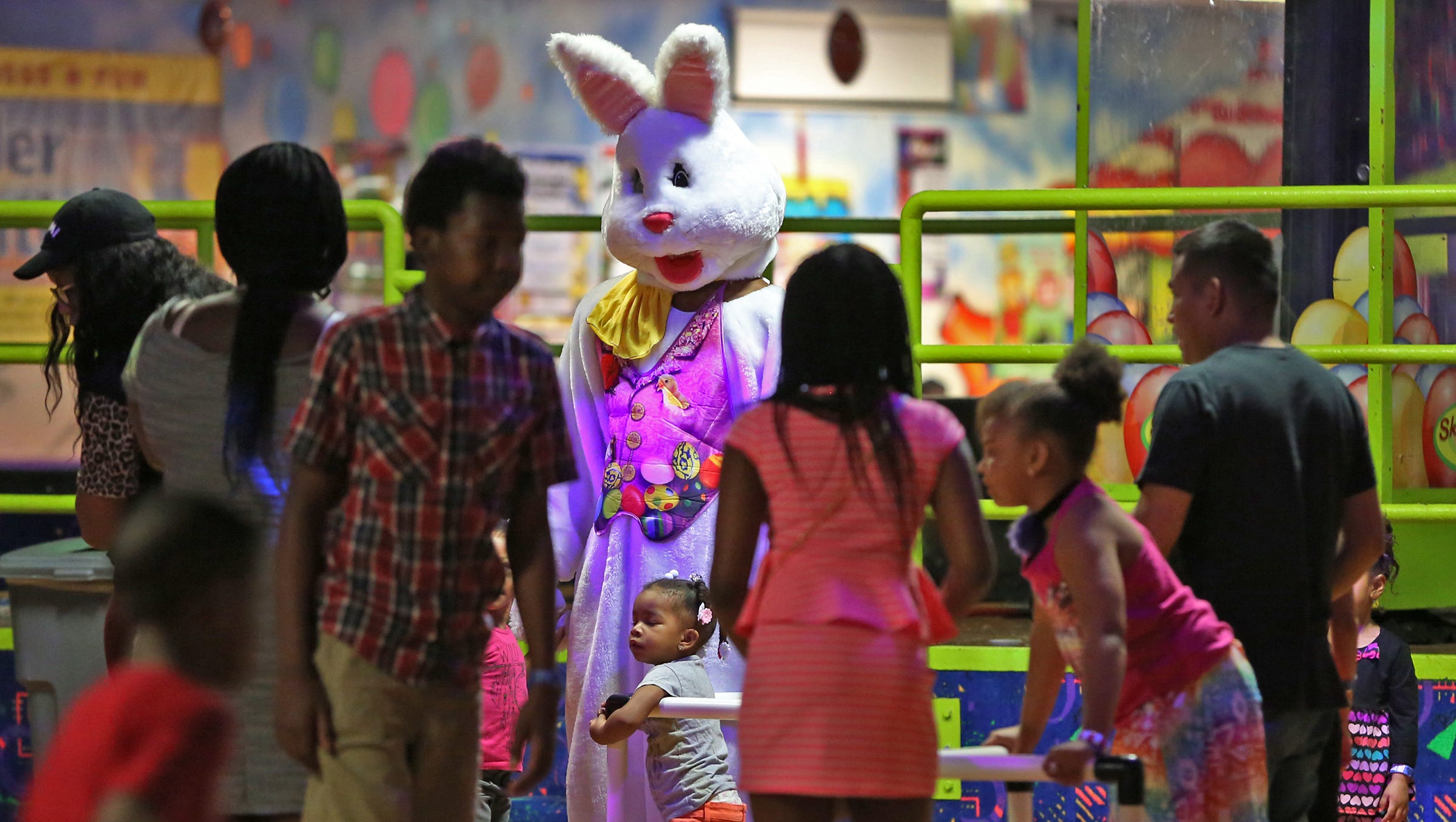 The Easter Bunny, Tashawn Carter, greets skaters during Skateland