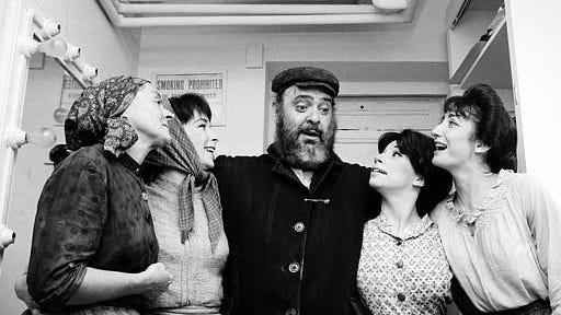 Actor Zero Mostel, center, who portrays Tevye in the musical "Fiddler on the Roof," poses backstage with cast members after the play