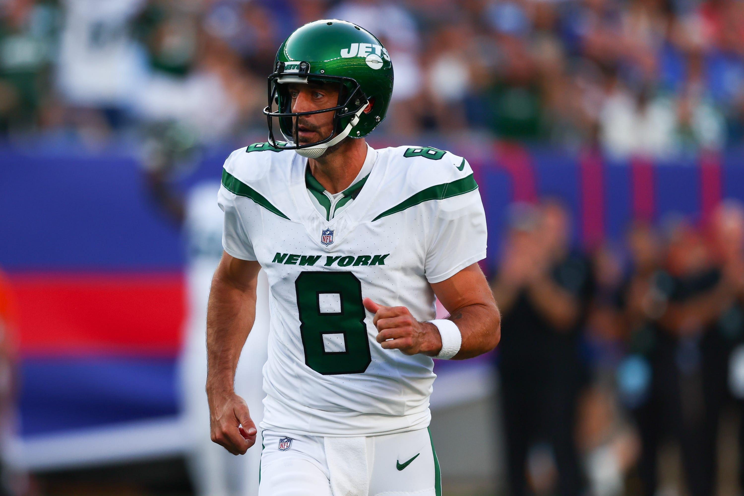 New York Jets quarterback Aaron Rodgers (8) celebrates his touchdown pass against the New York Giants during the first half at MetLife Stadium.