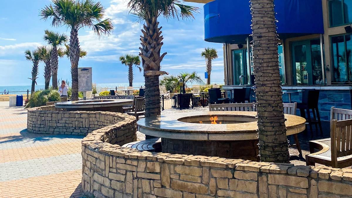 View of the outdoor dining area and fire pit at Catch 31 Fish House and Bar in Virginia Beach, Virginia, USA
