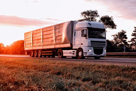 ltl truck driving at sunset on highway
