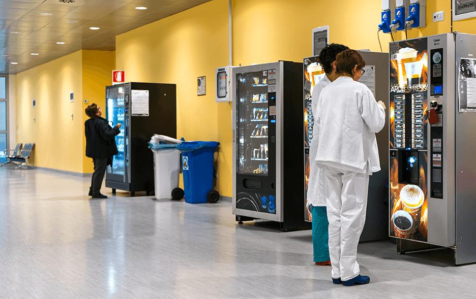 People buying from vending machine at the hospital