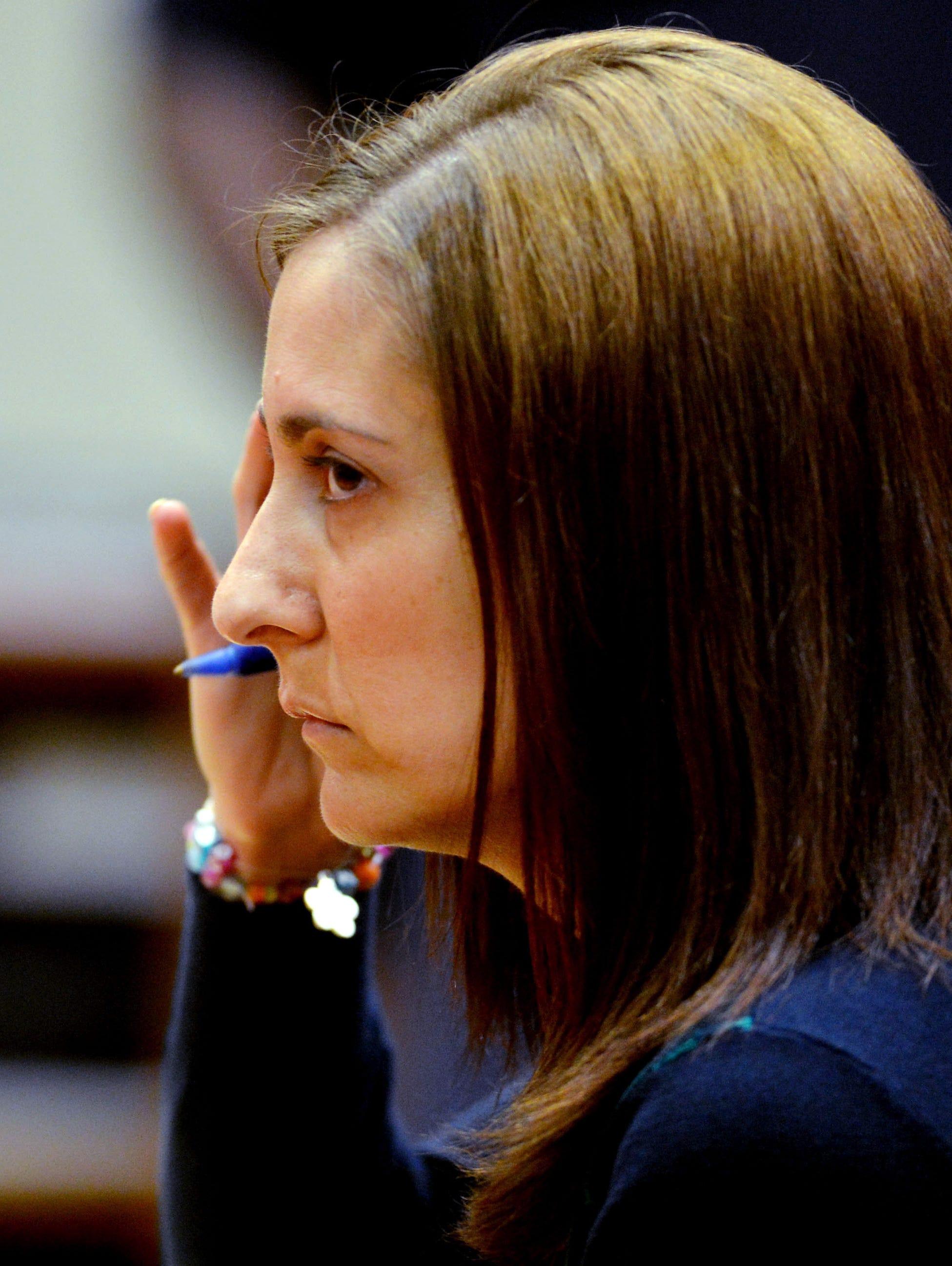 Andrea Sneiderman listens as the jury is polled on the verdict on her trial Aug. 19, 2013, in Decatur, Ga. Sneiderman was accused of lying to investigators about the death of her husband, Rusty.