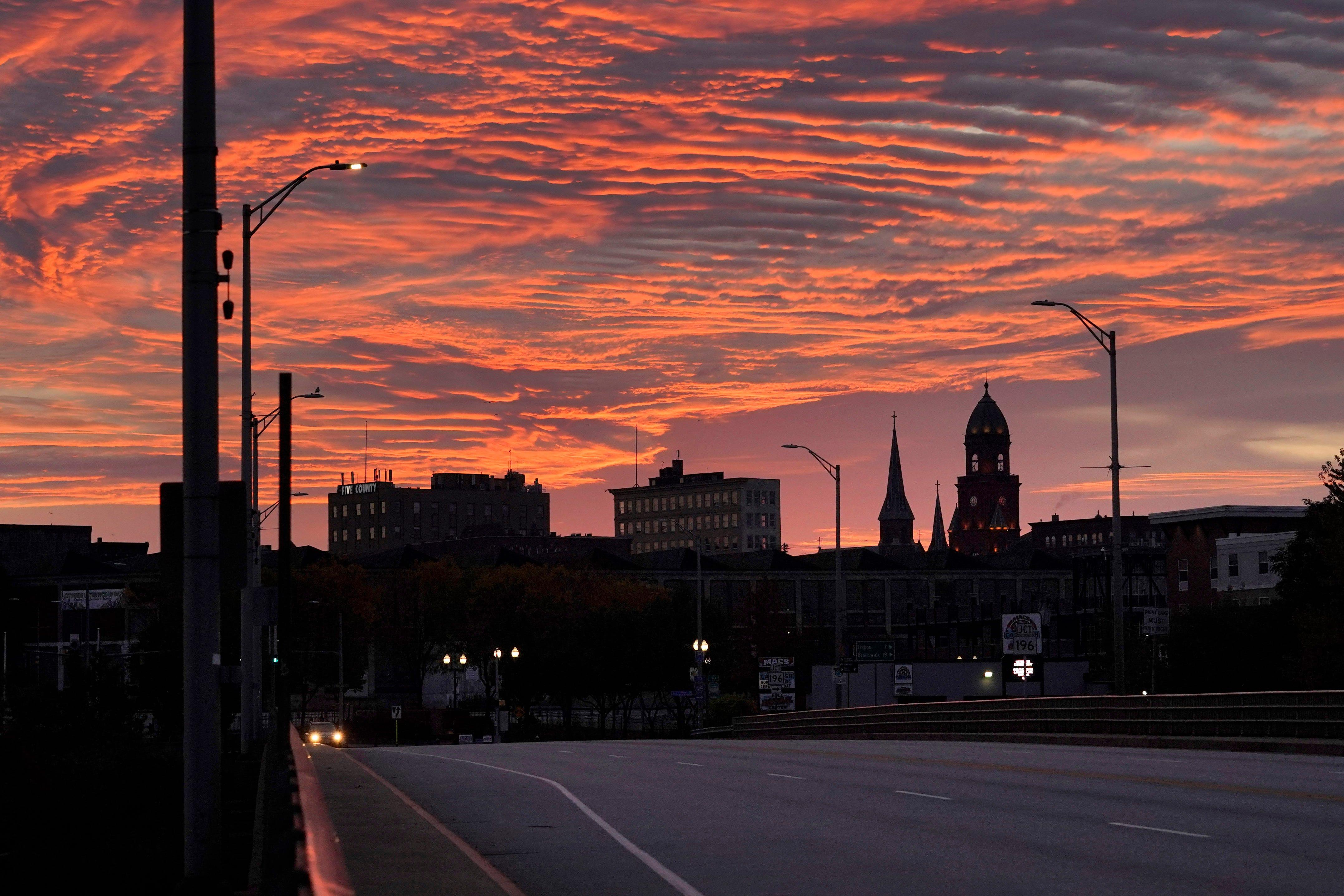 The skyline of in Lewiston, Maine is seen at dawn, Thursday, Oct. 26, 2023. Residents have been ordered to shelter in place as police continue to search for the person of interest of Wednesday