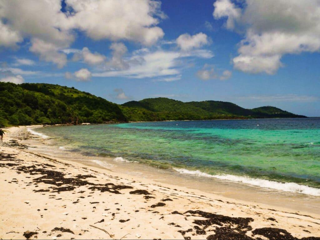 View of the calm Tamarindo Grande Beach and the lush mountain ranges on Flamenco