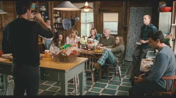 Dane Cook standing at kitchen island in cabin