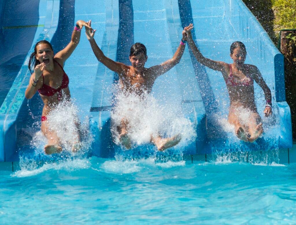 children enjoying a waterpark slide