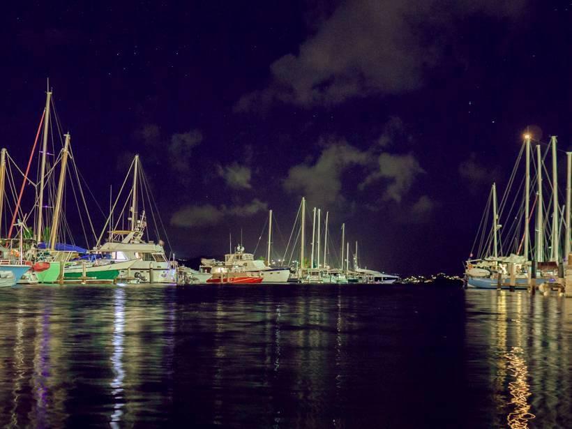 Boats docked and lit up in the Sapphire Bay Marina at night - st thomas vs st croix