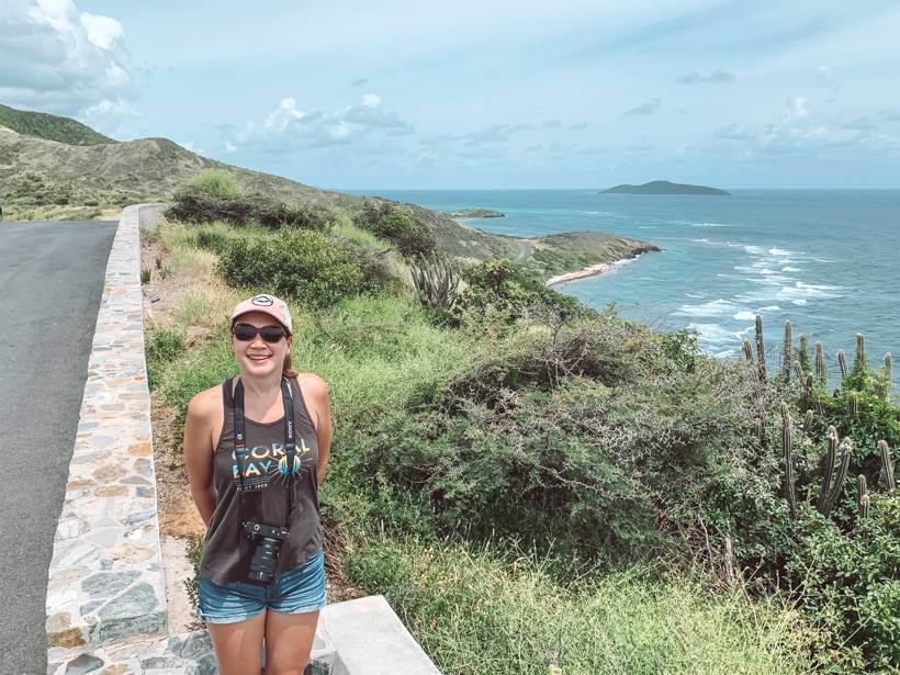 Girl standing along the road overlooking the sea - St Thomas vs St Croix