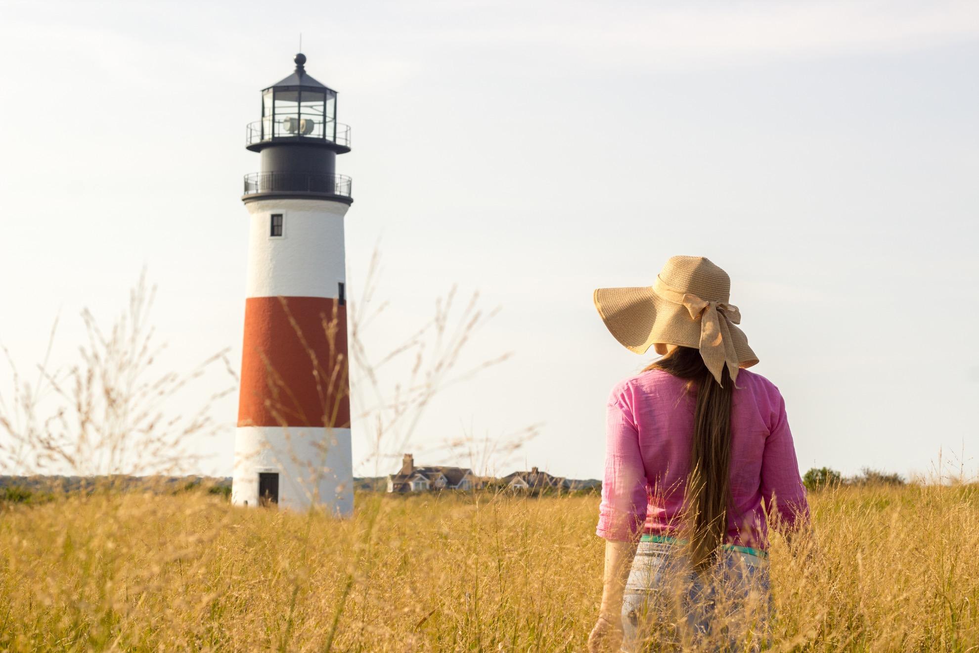 A woman near a lighthouse in Nantucket.