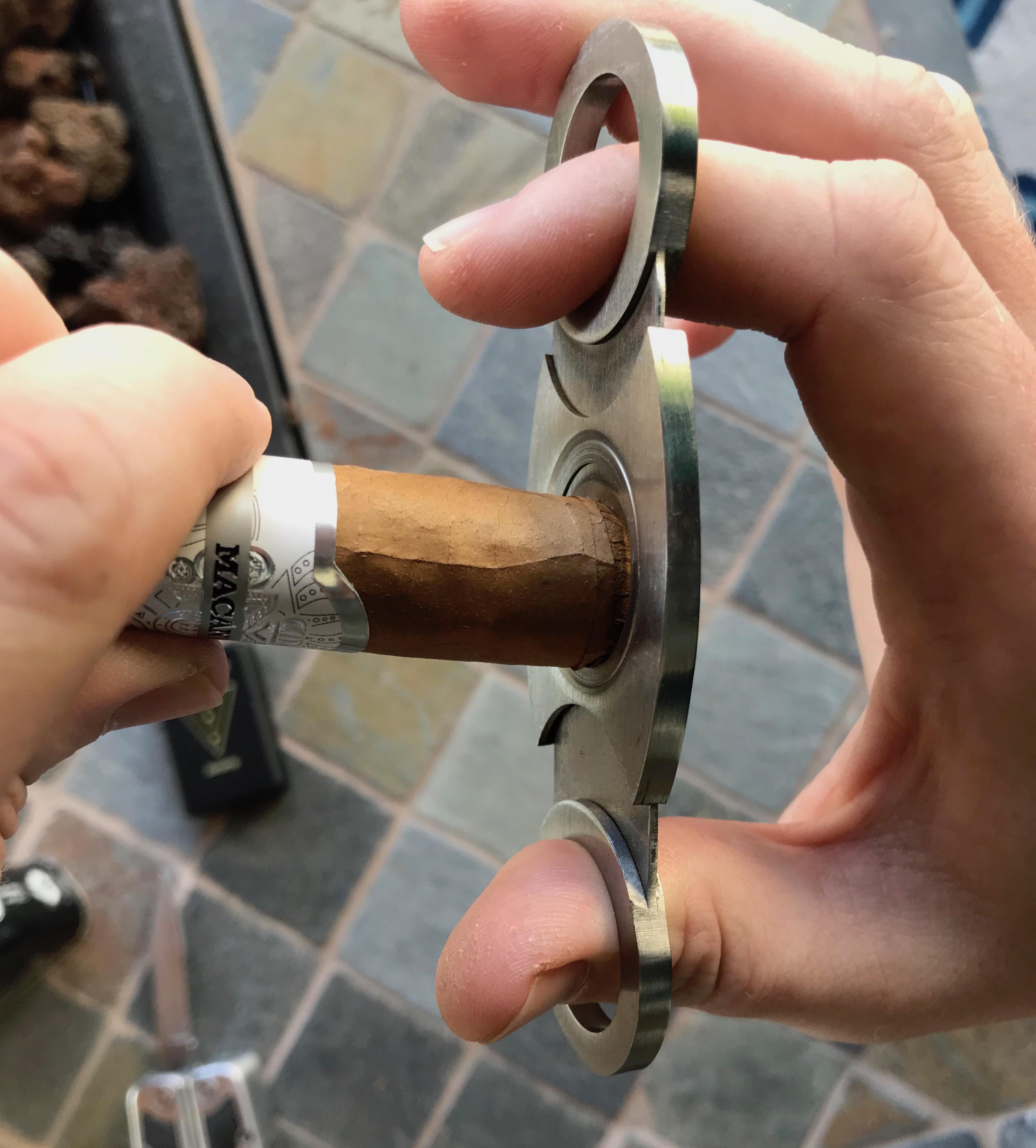 Cutting the cap of cigar.