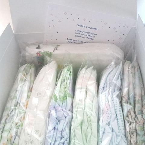 7 Diaper Sample Packs in a variety of brands in a white gift box
