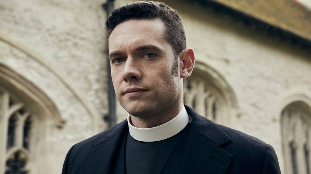 Tom Brittney as Will Davenport standing outside church in Grantchester Season 8