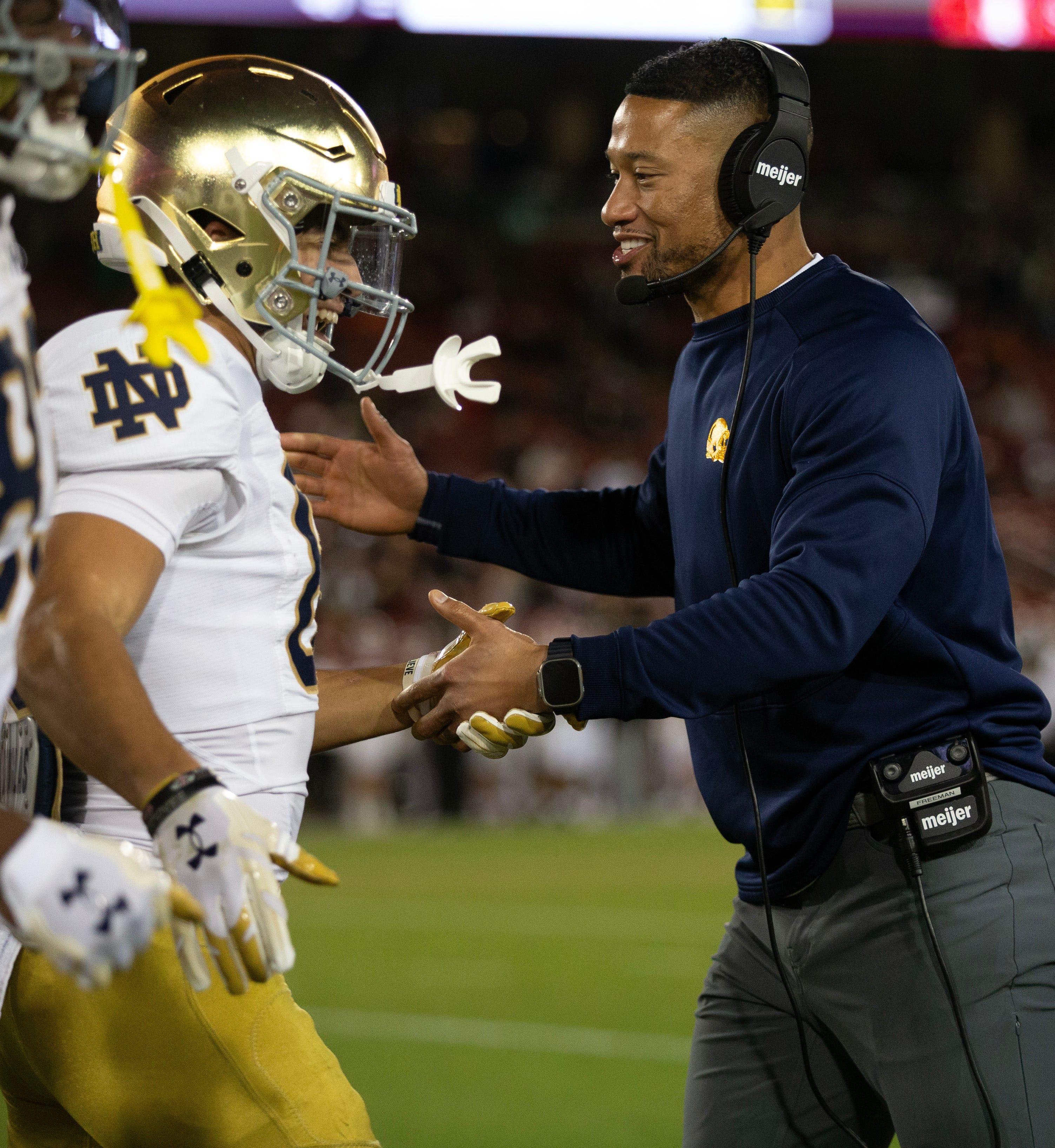 Nov 25, 2023; Stanford, California, USA; Notre Dame Fighting Irish head coach Marcus Freeman congratulates his players after they scored a touchdown against the Stanford Cardinal during the third quarter at Stanford Stadium. Mandatory Credit: D. Ross Cameron-USA TODAY Sports