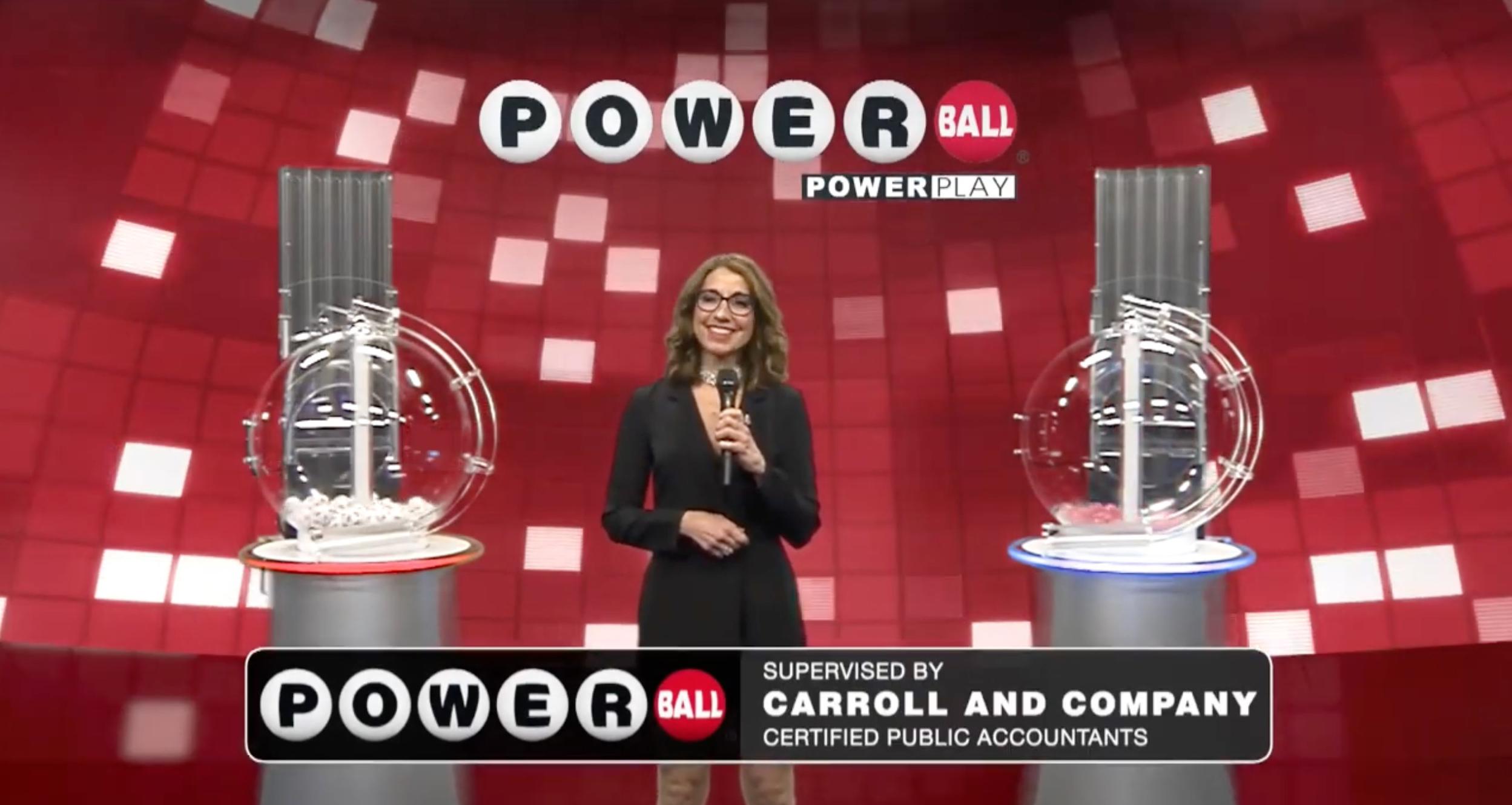 Laura Johnson hosting the Powerball lottery drawing, standing in front of a red and white wall, on April 6, 2024