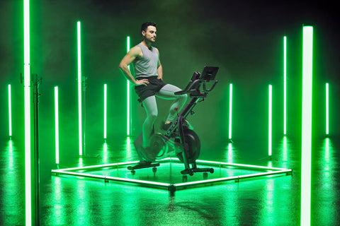 Man sitting on RE:GEN in green lit studio