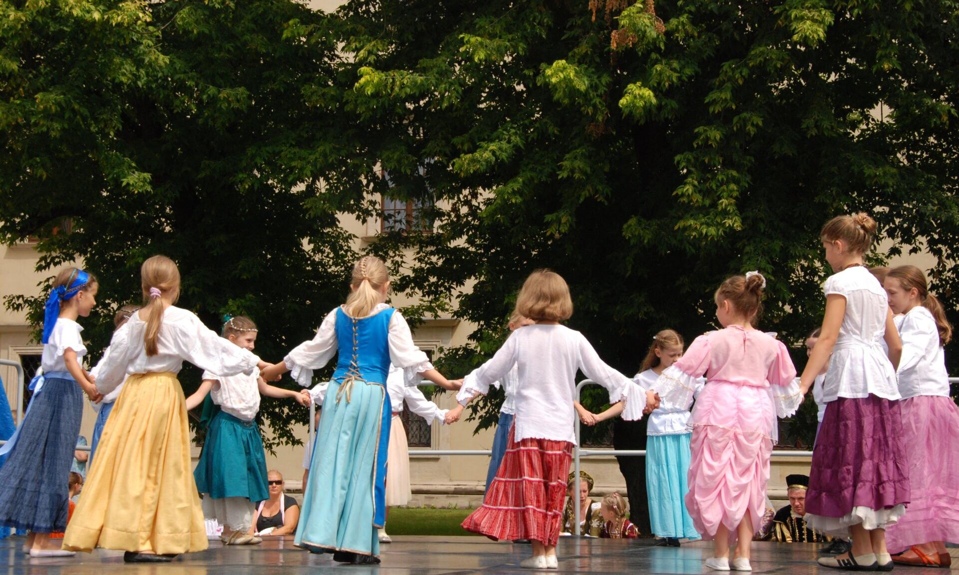 Do Baptists Dance, children in costume holding hands in a circle preparing to dance