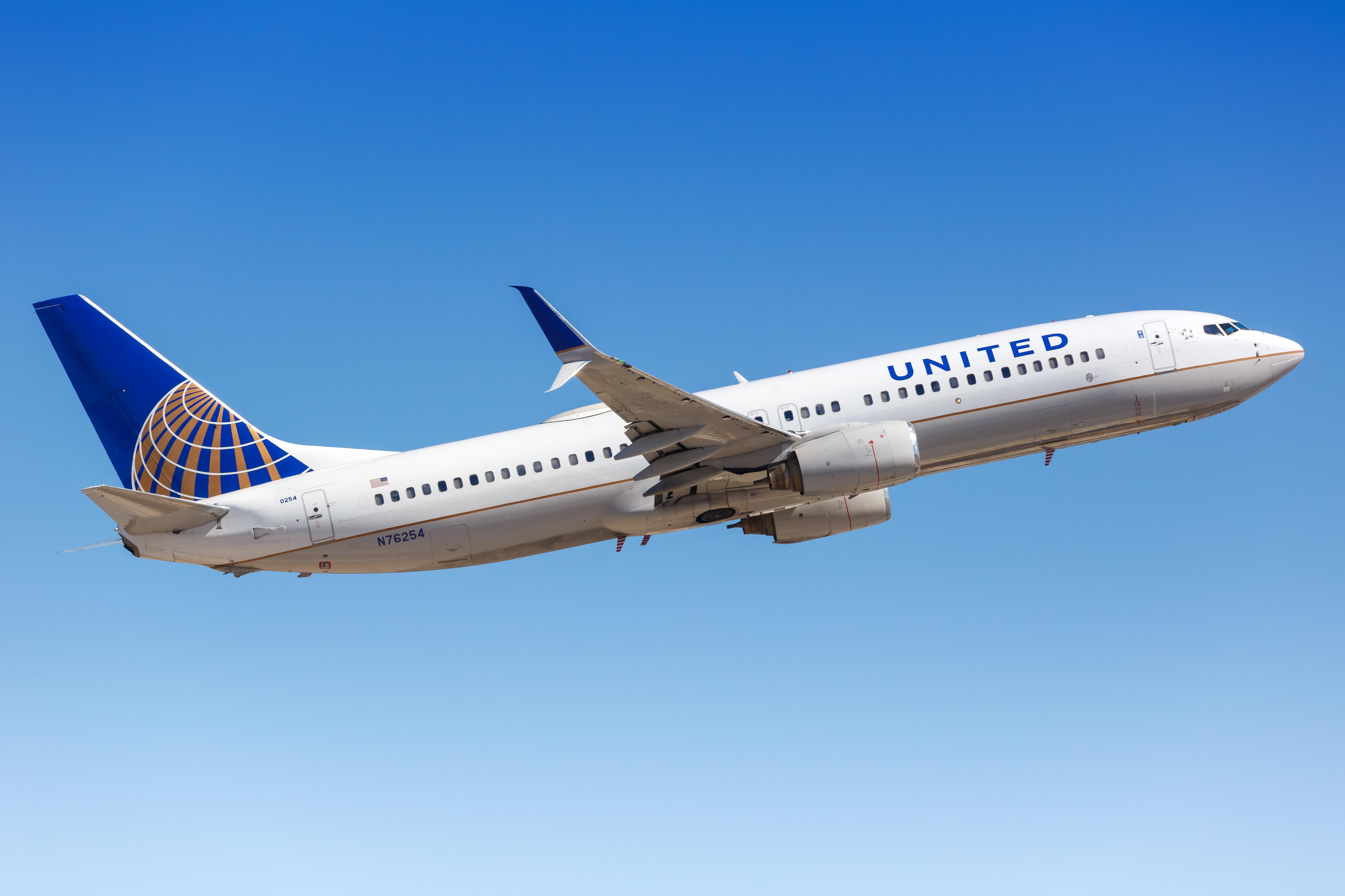 A white United Airlines Boeing 737-800 airplane on the ground at Phoenix Sky Harbor airport in Arizona, United States.
