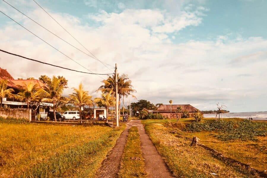 Dirt road around rice fields to the beach in Medewi, Bali